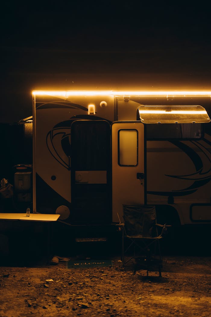 Home A dimly lit camper van with outdoor gear evokes adventure travel under a moody night sky.